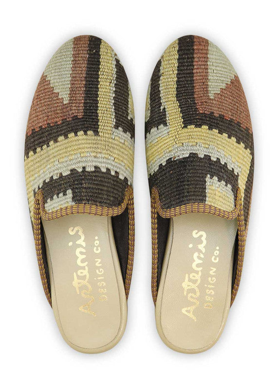 The Artemis Women's Slippers offer a sophisticated blend of colors, featuring black, brown, cream, and grey. These slippers seamlessly blend the classic appeal of black and brown with the neutral charm of cream and grey, creating a harmonious and versatile color combination. (Front View)