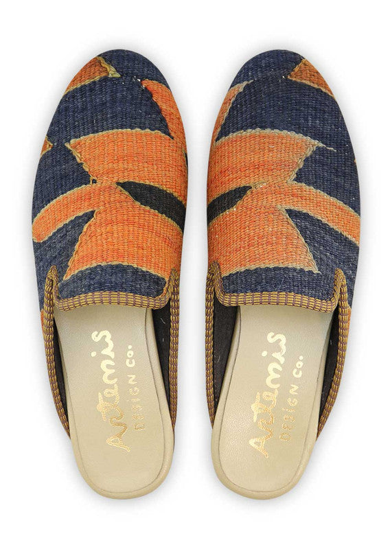 The Artemis Women's Slippers offer a captivating fusion of colors, featuring blue, orange, khaki, and rust. These slippers seamlessly blend the calming tones of blue with the energetic bursts of orange, complemented by the neutral charm of khaki and the warmth of rust. (Front View)