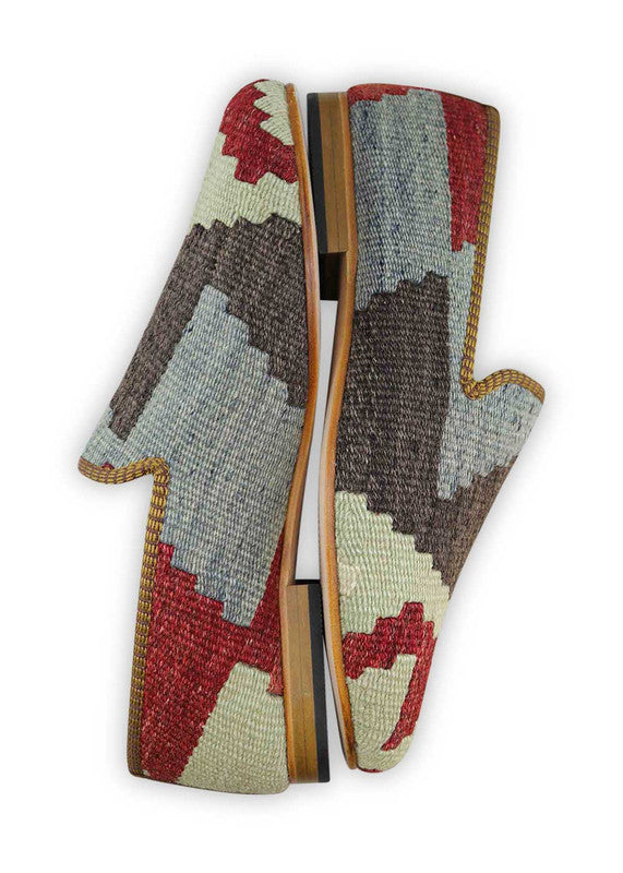 The Artemis Men's Smoking Shoe showcase a sleek color combination of white, red, dark grey, and blue. These slippers offer a balanced mix of bold and neutral tones, creating a versatile and stylish look. Whether you're unwinding at home or stepping out for a casual outing, these slippers are the perfect choice. (Side View)