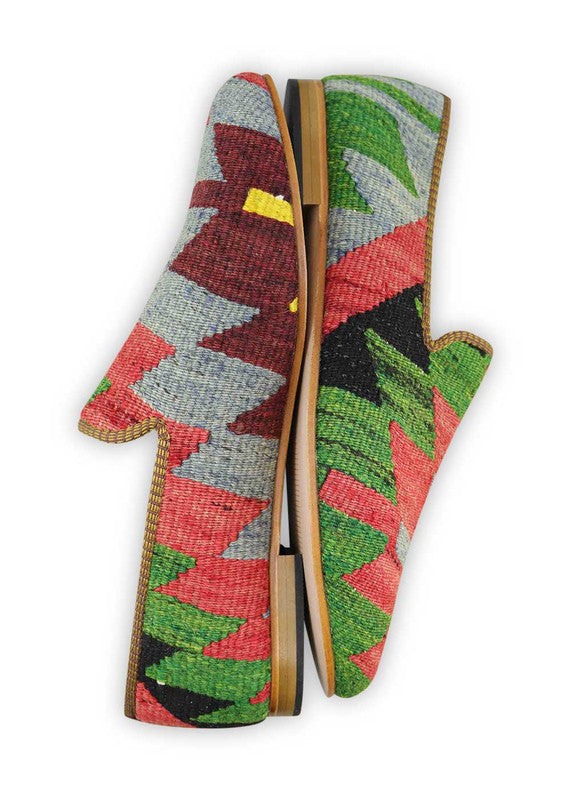  Artemis Shoes presents its striking men's loafers,the blue hue sets a tone of sophistication,  while the maroon adds a touch of richness and elegance.The vibrant red brings a bold and confident flair to the design, complemented by the refreshing green that adds a pop of nature-inspired charm.  The black accents provide a timeless and versatile element, the yellow highlights inject a vibrant energy that completes the ensemble with a playful and dynamic touch. (Side View)