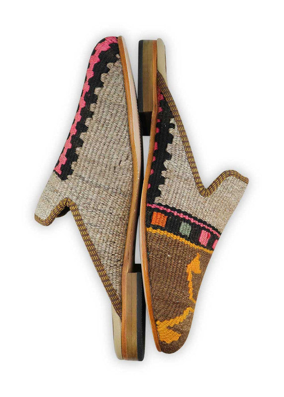 The Artemis Men's Slippers showcase a vibrant color combination of black, fuschia, orange, green, yellow orange, brown, and khaki. These slippers offer an energetic mix of bold and earthy tones, creating a stylish and eye-catching look. (Side View)