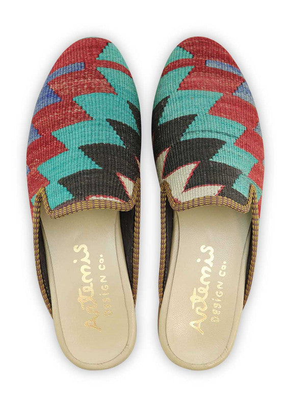 The Artemis Men's Slippers showcase a dynamic color combination of teal, black, white, and red. These slippers offer a striking mix of bold and neutral tones, creating a stylish and eye-catching look. Whether you're unwinding at home or stepping out for a casual outing, these slippers are the perfect choice. (Front View)