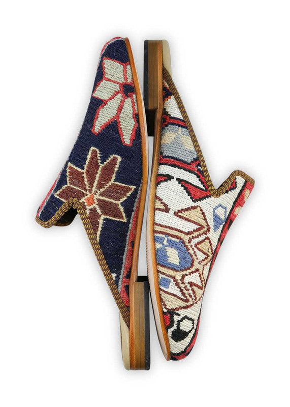 The Artemis Men's Slippers feature a dynamic color combination of navy blue, white, red orange, maroon, khaki, brown, black, and white. These slippers offer a vibrant mix of bold and neutral tones, creating a stylish and eye-catching look. Whether you're unwinding at home or stepping out for a casual outing, these slippers are the perfect choice. (Side View)