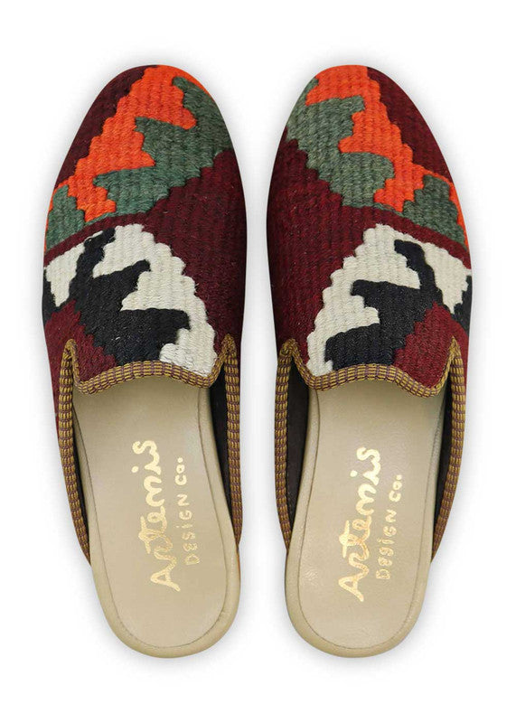 The Artemis Men's Slippers feature a captivating color combination of maroon, orange, grey, white, and black. These slippers offer a lively and balanced mix of warm and neutral tones, creating a stylish and versatile look. (Front View)