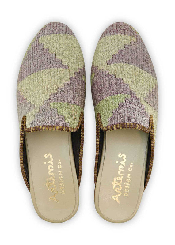 The light grey base provides a neutral backdrop, while the accents of light green and red add a vibrant pop of color. The intricate patterns and designs of the Kilim fabric give the slippers a distinct and unique look. (Front View)