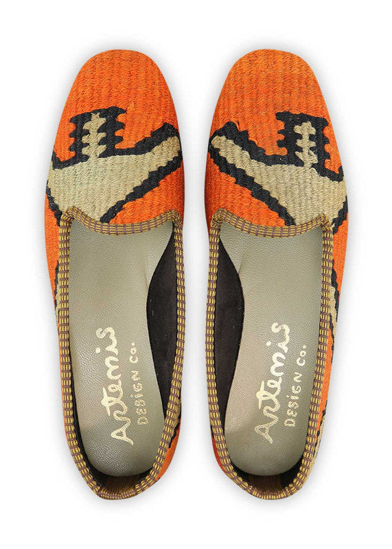 These loafers exude a modern and sophisticated vibe with their minimalistic yet striking color palette. The vibrant orange hue adds a bold pop of color, while the khaki and black tones provide a neutral and timeless foundation. With their comfortable fit and classic loafer design, these Artemis Women's Loafers are perfect for adding a touch of style to your everyday look. (Front View)